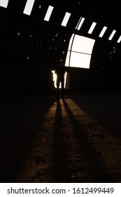 A man legs shadow inside a dark cottage house and sunlight is coming from window.