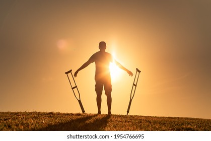 Man letting go of crutches able to walk again. Body recovery, healing, and miracle concept. 