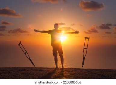 Man letting go of crutches recovering from physical injury.  Healing your body recovery concept. 