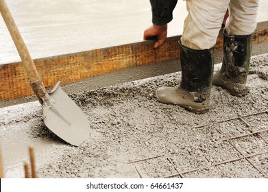 Man Leveling Concrete Slab