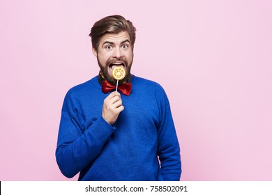 Man Licking A Lollipop At Studio Shot