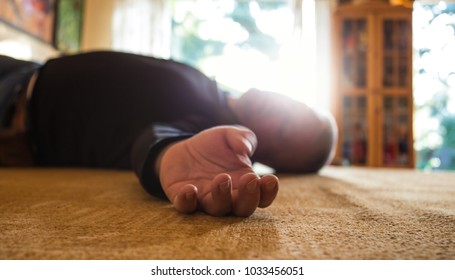 a man lies unconscious in his apartment - Shutterstock ID 1033456051