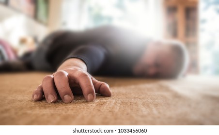 a man lies unconscious in his apartment - Shutterstock ID 1033456060