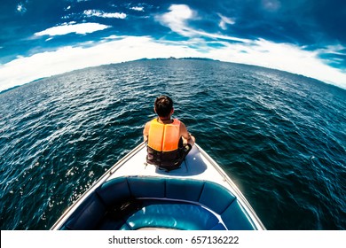 Man In Life Orange Life Jackets Sit On Speed Boat Front View, Lonely Man