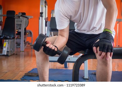 A Man Lifting Up Dumbell In Gym