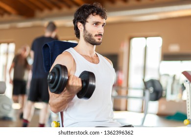 Man Lifting Weight At The Gym