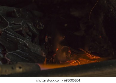 A Man IS Lighting Charcoal With Propane Torch On Home Made Grill Close Up