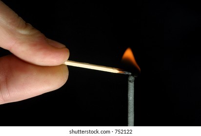 Man Lighting A Fuse With A Safety Match