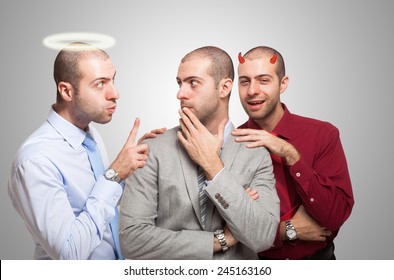 Man listening to the angel and devil self to make a choice - Powered by Shutterstock