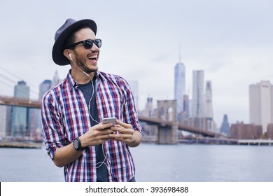 Man listening music with his smartphone in Brooklyn, New York - Powered by Shutterstock