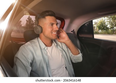 Man Listening To Music In Modern Taxi