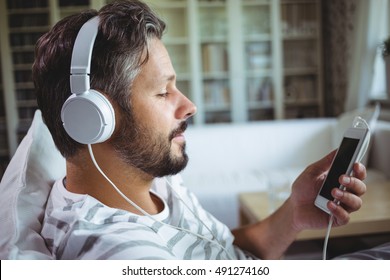 Man Listening To Music On Headphones At Home