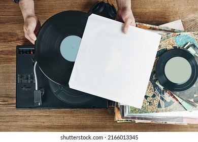 Man Listening To Music From Vinyl Record. Playing Music From Analog Disk On Turntable Player. Enjoying Music From Old Collection. Relaxing At Home. Retro And Vintage. Music Passion