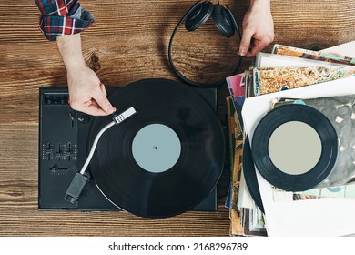 Man Listening To Music From Vinyl Record. Playing Music From Analog Disk On Turntable Player. Enjoying Music From Old Collection. Relaxing At Home. Retro And Vintage. Music Passion