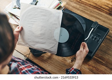 Man Listening To Music From Vinyl Record. Playing Music From Analog Disk On Turntable Player. Enjoying Music From Old Collection. Relaxing At Home. Retro And Vintage. Music Passion