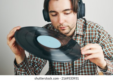 Man Listening To Music From Vinyl Record. Playing Music From Analog Disk On Turntable Player. Enjoying Music From Old Collection. Relaxing At Home. Retro And Vintage. Music Passion