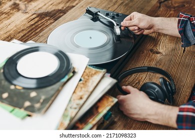 Man Listening To Music From Vinyl Record. Playing Music From Analog Disk On Turntable Player. Enjoying Music From Old Collection. Relaxing At Home. Retro And Vintage. Music Passion