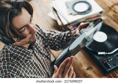 Man Listening To Music From Vinyl Record. Playing Music From Analog Disk On Turntable Player. Enjoying Music From Old Collection. Relaxing At Home. Retro And Vintage. Music Passion