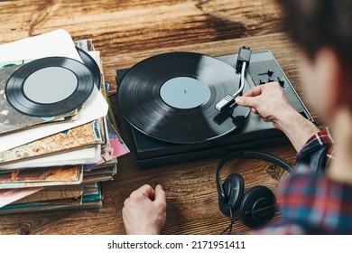 Man Listening To Music From Vinyl Record. Playing Music From Analog Disk On Turntable Player. Enjoying Music From Old Collection. Relaxing At Home. Retro And Vintage. Music Passion