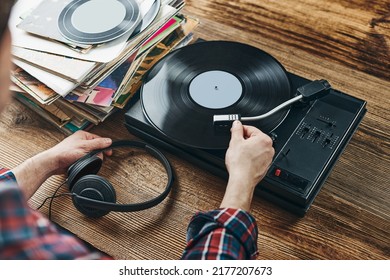 Man Listening To Music From Vinyl Record. Playing Music From Analog Disk On Turntable Player. Enjoying Music From Old Collection. Relaxing At Home. Retro And Vintage. Music Passion