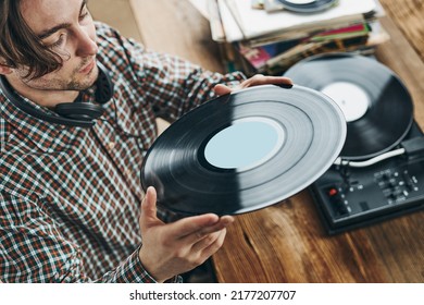 Man Listening To Music From Vinyl Record. Playing Music From Analog Disk On Turntable Player. Enjoying Music From Old Collection. Relaxing At Home. Retro And Vintage. Music Passion