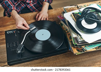 Man Listening To Music From Vinyl Record. Playing Music From Analog Disk On Turntable Player. Enjoying Music From Old Collection. Relaxing At Home. Retro And Vintage. Music Passion