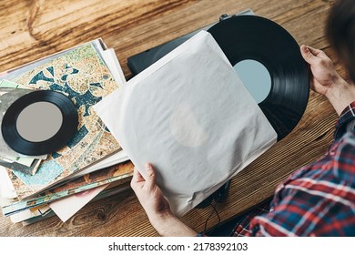 Man Listening To Music From Vinyl Record. Playing Music From Analog Disk On Turntable Player. Enjoying Music From Old Collection. Relaxing At Home. Retro And Vintage. Music Passion