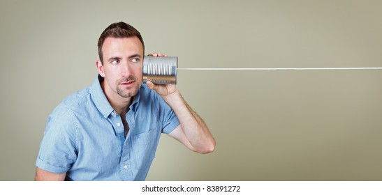 Man listening to tin can telephone