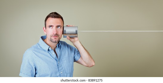 Man listening to tin can telephone
