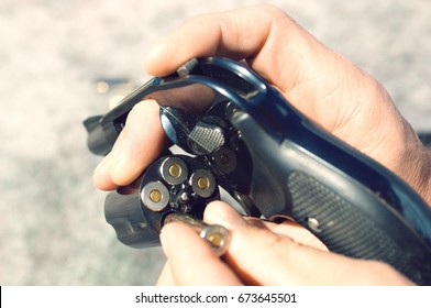 Man Loading Bullets Into Gun, Close-up Of Hands