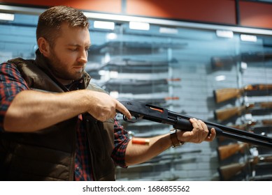 Man Loads New Rifle At Counter In Gun Shop