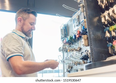 Man Locksmith Choosing Key Blank In His Shop