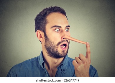 Man with long nose isolated on grey wall background. Liar concept. Human face expressions, emotions, feelings. - Shutterstock ID 326247749