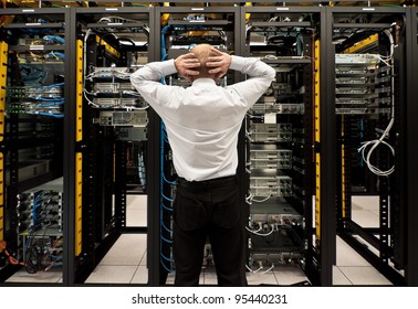 Man looking astonished in a network data center.