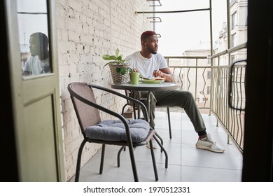 Man Looking Away While Eating Scrambled Eggs At The Breakfast