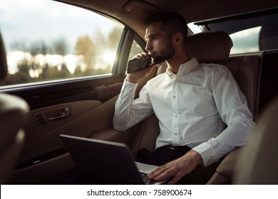 Man Looking Away While Sitting On The Back Seat Of A Car, Businessman In Taxi