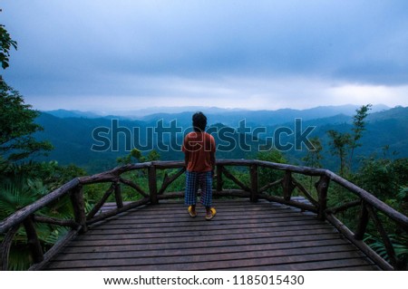 A man looking at a beautiful mountain range in Thong Pha Phoom National Park, Kanchanaburi 