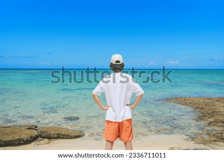 Man looking at a beautiful tropical beach