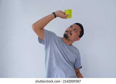 Man Looking The Bottom Of Drinking Glass