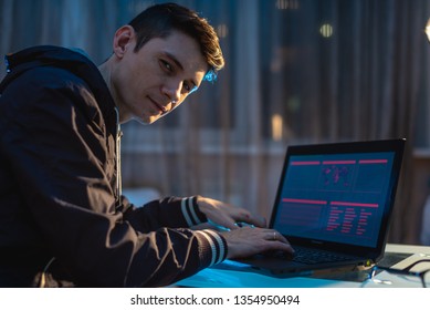 Man looking in the camera. Hacker attacks and stealing access databases with passwords. The concept of cyber security