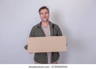 Man looking at camera, holding empty brown cardboard box, ready for packing, receiving, or displaying custom text and branding