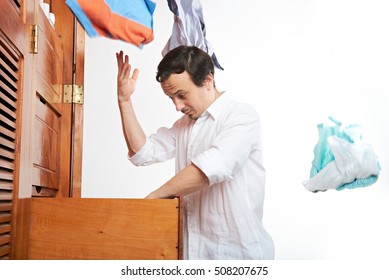 Man Looking Clothes In Closet. Young Men Throw Dress Form Wardrobe Isolated On White Background