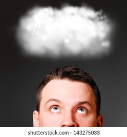 man is looking up at clouds