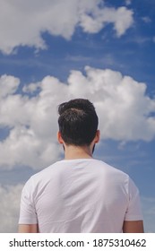 Man looking at a cloudy sky