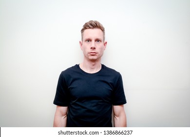 Man Looking Directly Into Camera, Model Not Smiling And Facing Forwards