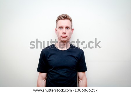 Man looking directly into camera, model not smiling and facing forwards