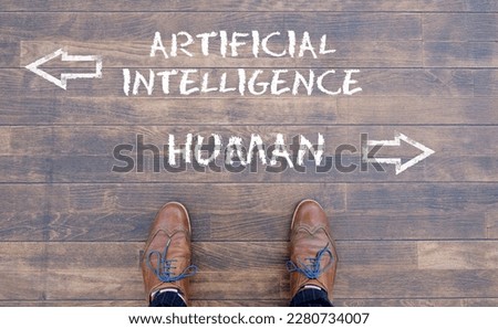 Man looking down at the words Artificial Intelligence - AI - and Human chalked onto the floor