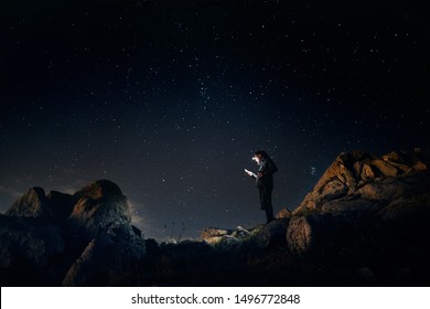 Man Is Looking At His Phone With His Head Light At Starry Night The Mountains 