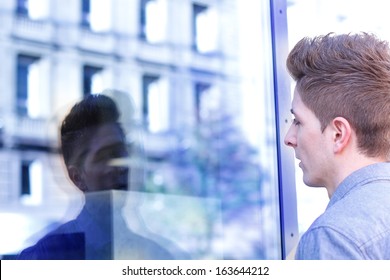 Man looking at his reflection - Powered by Shutterstock