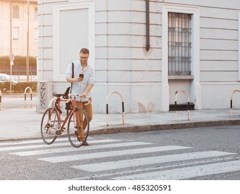 Man looking at his smartphone while walking in the city street - Powered by Shutterstock